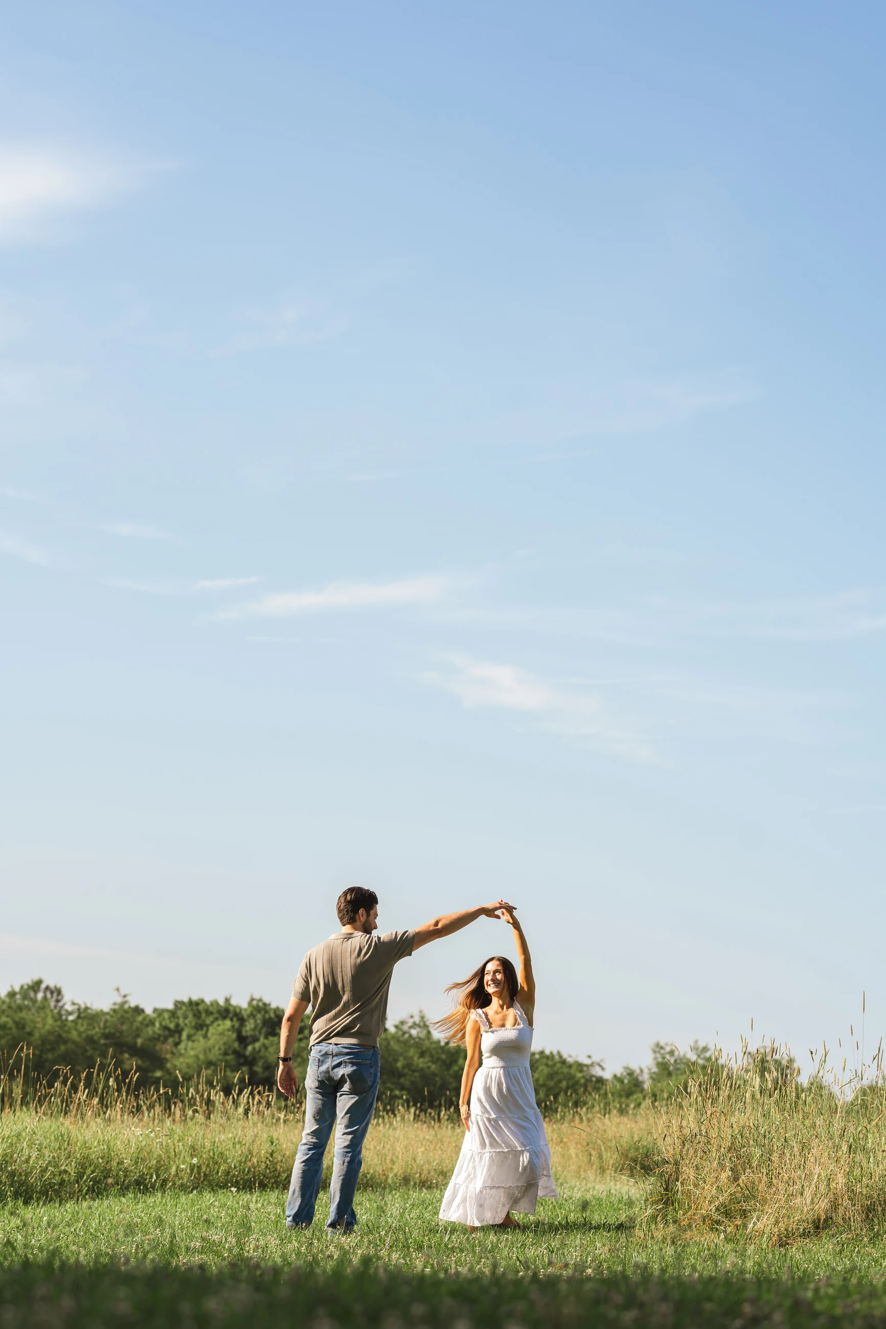 Parents dancing together in a wide open field