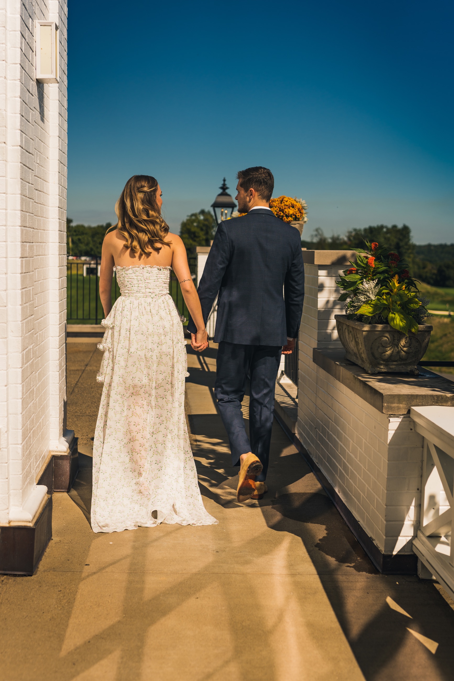 Couple walking hand in hand after a bridal shower