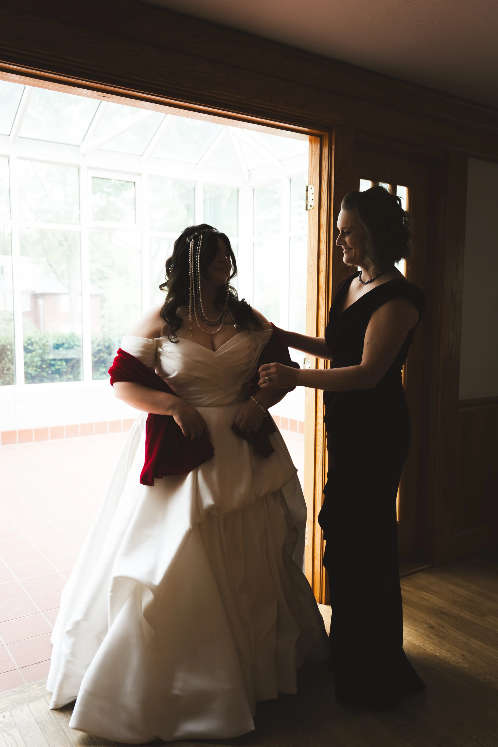 Bride getting ready in warm window light
