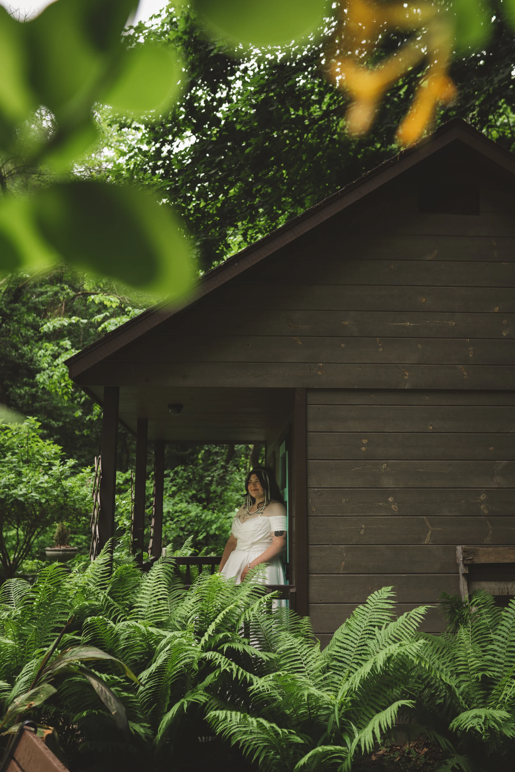 Couple framed by deep green woodland foliage